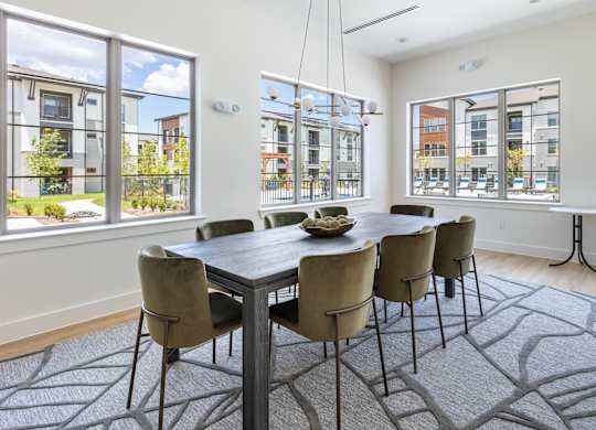 A dining room with a table and chairs.