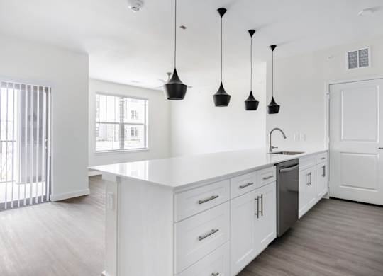 A kitchen with white cabinets and a white counter top.