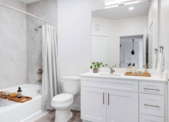 A white bathroom with a toilet, sink, and bathtub at 901 Rendon, Burleson, TX