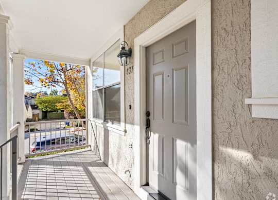 A white door is on the right side of a hallway at Westmont Place Townhomes Apartments, Santa Cruz