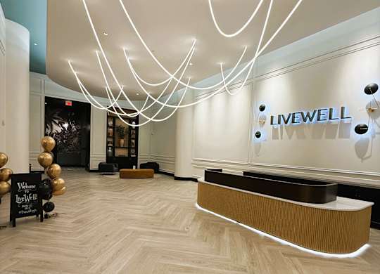 A reception area with a white reception desk and a sign that says