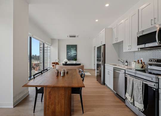 A modern kitchen with a wooden island and stainless steel appliances at 7 West 7th Apartments, Cincinnati, 45202