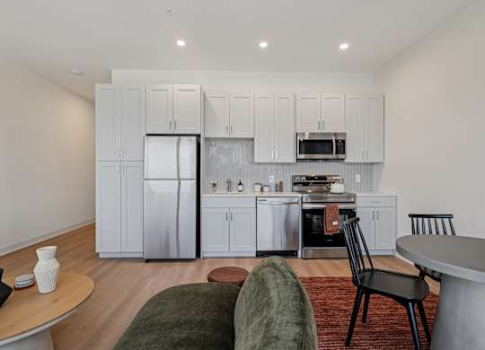 A modern kitchen with a refrigerator, oven, and microwave at 7 West 7th Apartments, Cincinnati, OH 45202