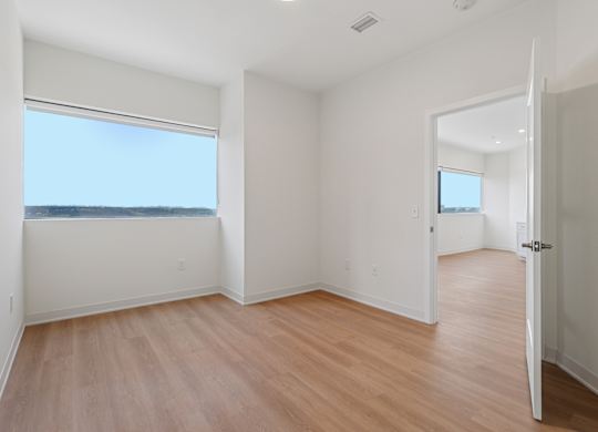 A room with a wooden floor and white walls at 7 West 7th Apartments, Cincinnati, OH 45202