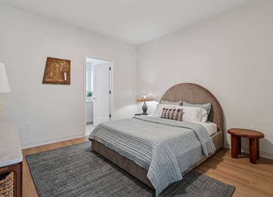 A bedroom with a large bed and a small table at 7 West 7th Apartments, Cincinnati, OH