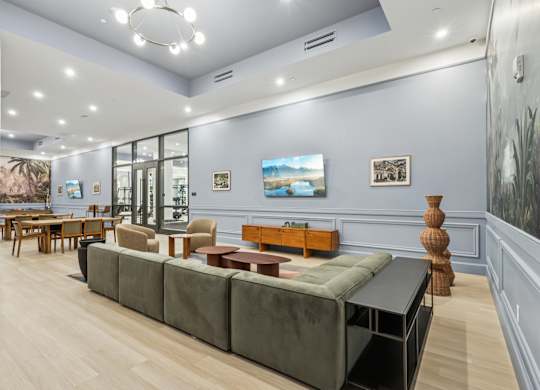A living room with a grey couch and a wooden table at LiveWell Apartments, Pittsburgh 15222