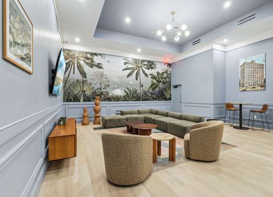 A living room with a couch, chairs, and a coffee table. at LiveWell Apartments, Pittsburgh, Pennsylvania