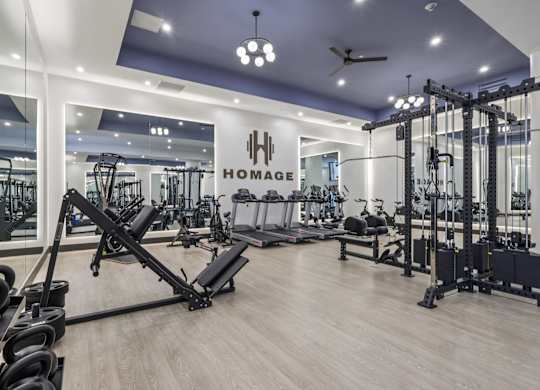 A gym with a variety of equipment including weights and cardio machines. at LiveWell Apartments, Pittsburgh, PA, 15222
