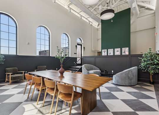 A long wooden table is surrounded by chairs in a room with a checkered floor. at LiveWell Apartments, Pennsylvania, 15222