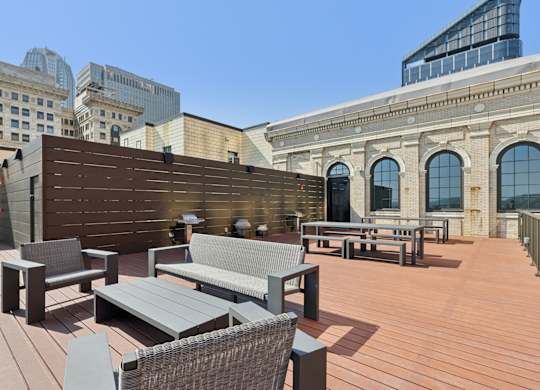 A wooden deck with a bench and a table. at LiveWell Apartments, Pittsburgh 15222