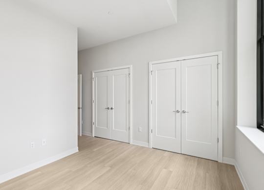 Three white doors are in a room with wood floors at LiveWell Apartments, Pennsylvania, 15222