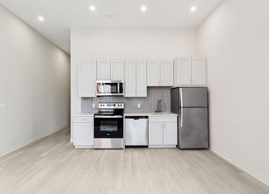 A kitchen with white cabinets and stainless steel appliances. at LiveWell Apartments, Pennsylvania
