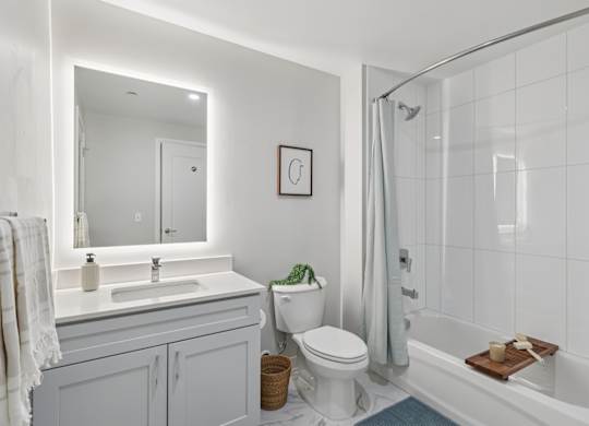 A white bathroom with a toilet, sink, and bathtub. at LiveWell Apartments, Pittsburgh, Pennsylvania
