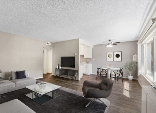 the living room of an apartment with a couch and a chair