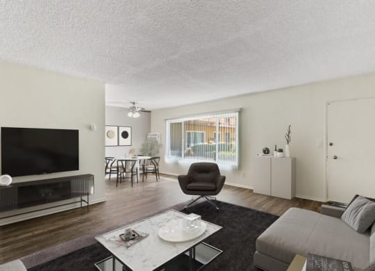 the living room of an apartment with a couch and a tv
