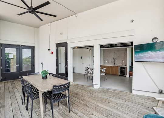 A dining room with a wooden table and chairs.