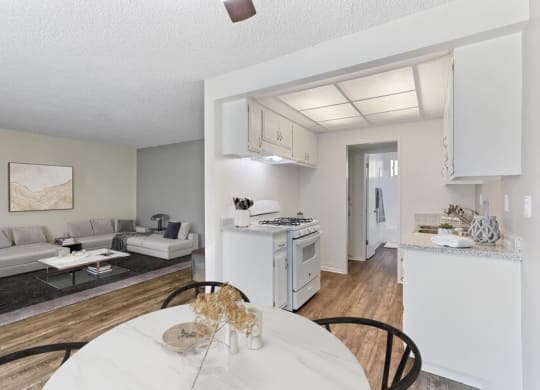 an open living room and kitchen with a table and chairs