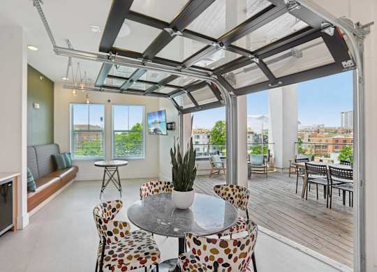 A modern dining room with a glass table and chairs.