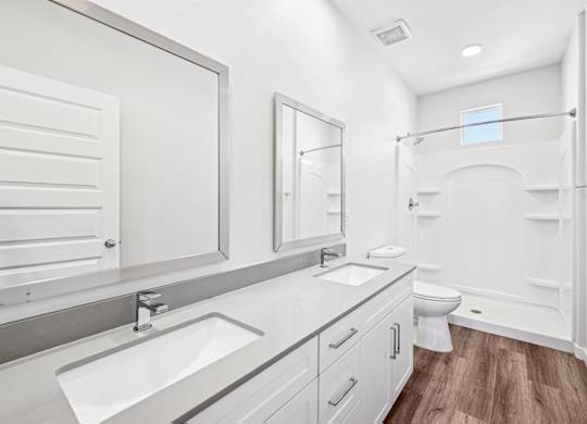 Baseline on 16th townhome white bathroom with a wooden floor and a toilet in the corner.