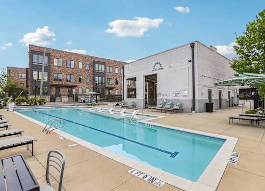 A pool area with a building in the background.
