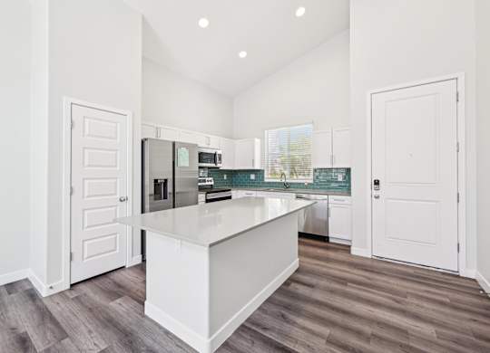 Baseline on 16th townhome kitchen with white cabinets and a white island.