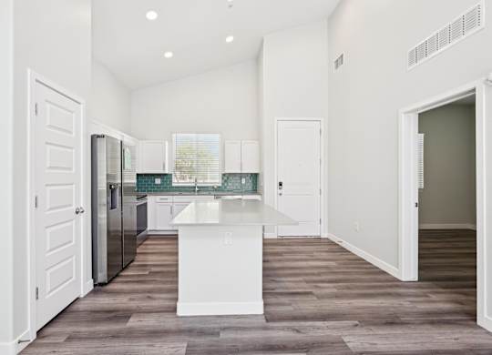 Baseline on 16th townhome kitchen with white cabinets and a white island.
