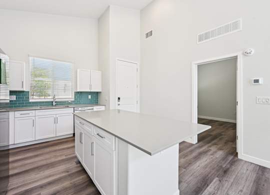 Baseline on 16th townhome kitchen with white cabinets and a white countertop.
