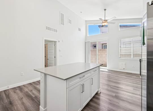 Baseline on 16th townhome kitchen with a white countertop and wooden floors.