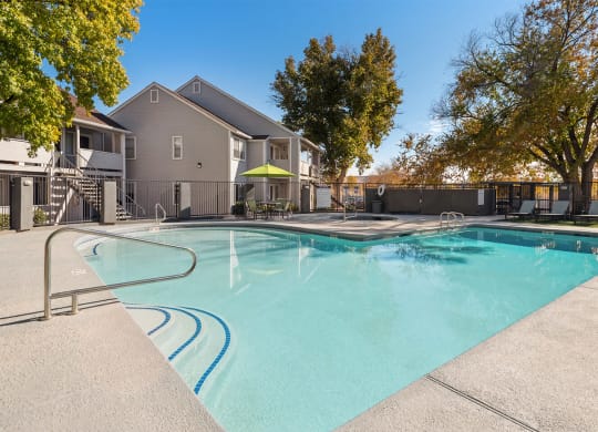 our apartments have a resort style pool with trees at Bella Vista, St. George, Utah