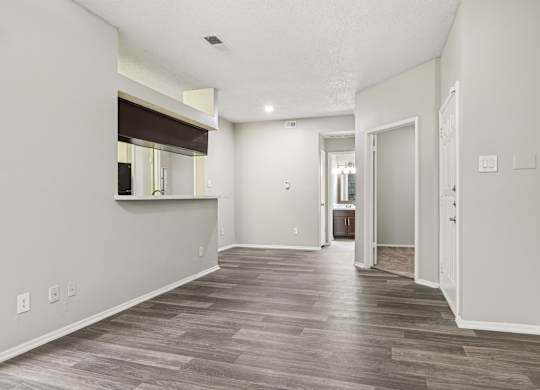 A room with a wooden floor and white walls.