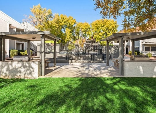 a backyard with a patio with shade structures at Bella Vista, Utah