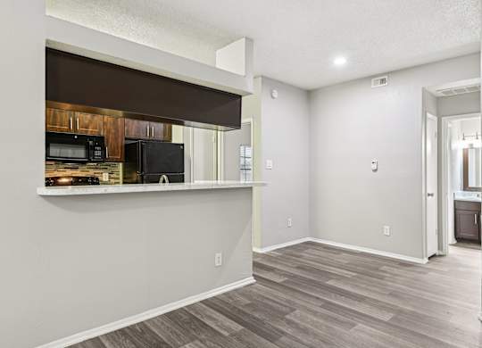 A kitchen area with a microwave and oven on the counter.