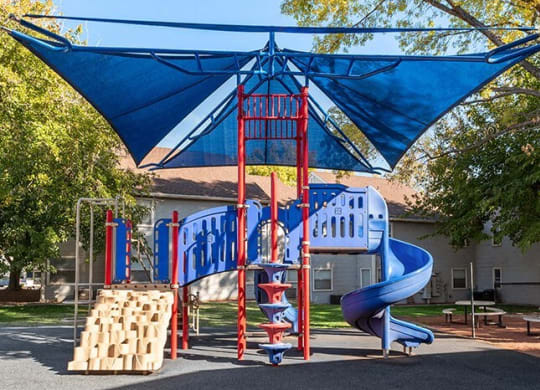 a blue and red playground with a blue slide  at Bella Vista, St. George, UT