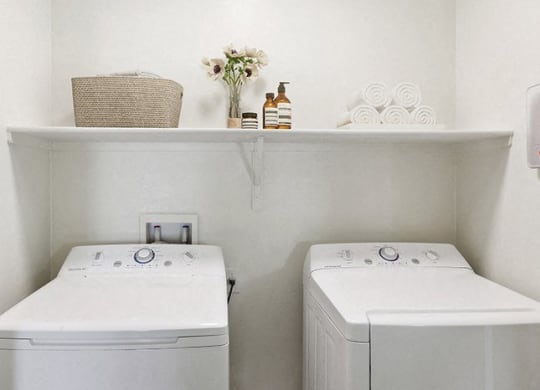 a small laundry room with two washes and a dryer at Galeria Del Rio, Tucson, Arizona