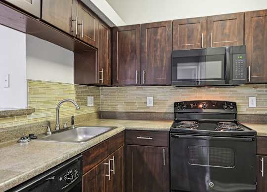 A black stove top oven with a microwave above it.