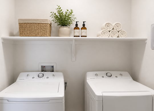 A white bathroom with two sinks and a shelf above them.
