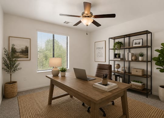 A room with a desk, chair, and a plant.