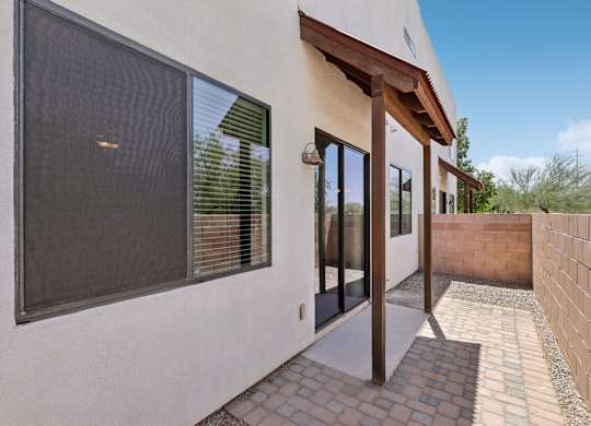 A modern house with a patio and a glass door.