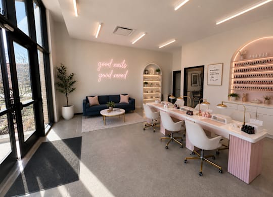A nail salon with a neon sign that says