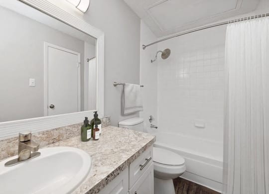 a white bathroom with a sink and a toilet at Heatherstone, Dallas
