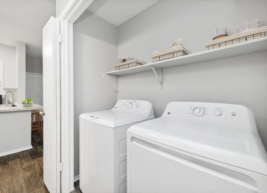 a washer and dryer in a laundry room with a sink at Heatherstone, Texas
