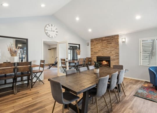 a dining room with a wooden table and chairs and a fireplace at Bella Vista, St. George, Utah