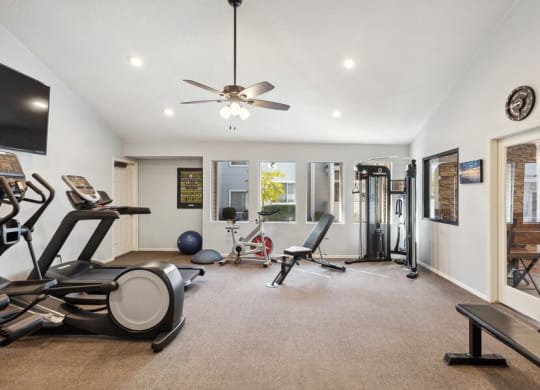 a home gym with weights and a ceiling fan at Bella Vista, St. George