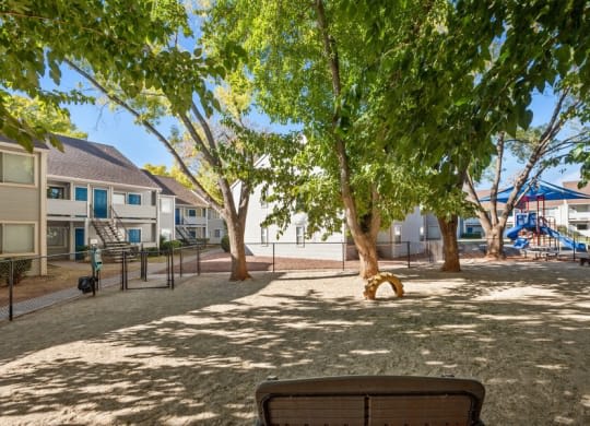 a park with benches and trees in front of houses at Bella Vista, Utah