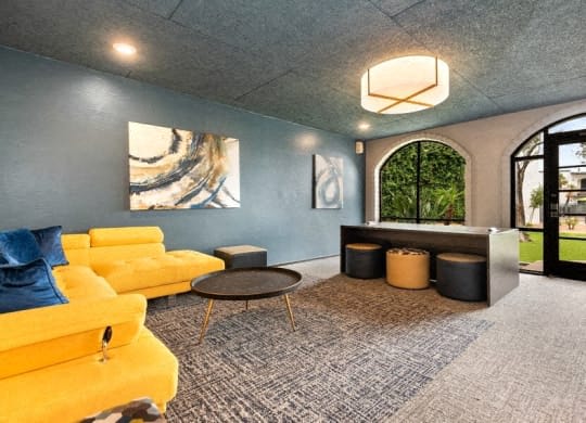 a living room with blue and yellow couches and a table at Vertu, Phoenix, AZ, 85014