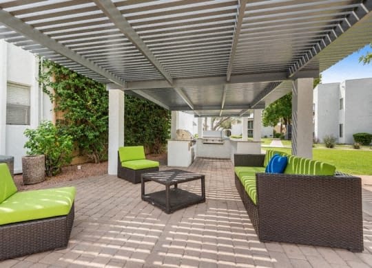 a patio with couches and a table under a roof at Vertu, Arizona