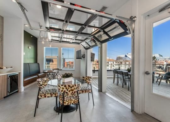 a living room with a glass ceiling and a table and chairs at Smith and Porter, Georgia