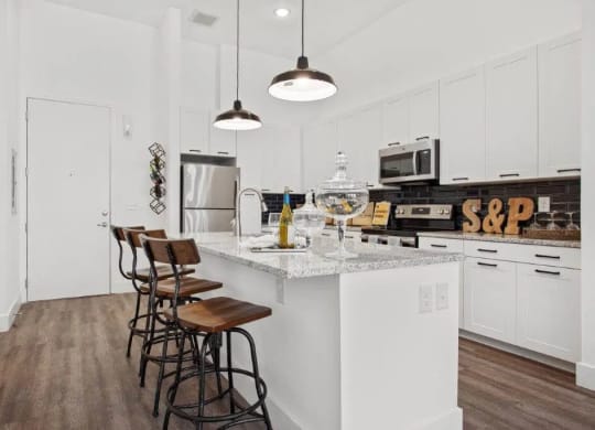 a kitchen with white cabinets and a counter top at Smith and Porter, Atlanta
