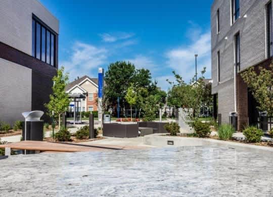 A modern courtyard with a water feature and contemporary buildings.