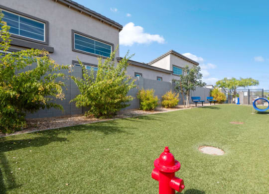 a red fire hydrant in the grass in front of a houseat Baseline on 16, Arizona